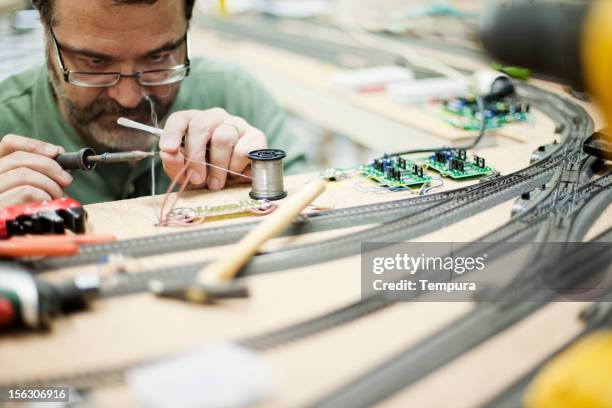 model train builder working. - miniature train stock pictures, royalty-free photos & images