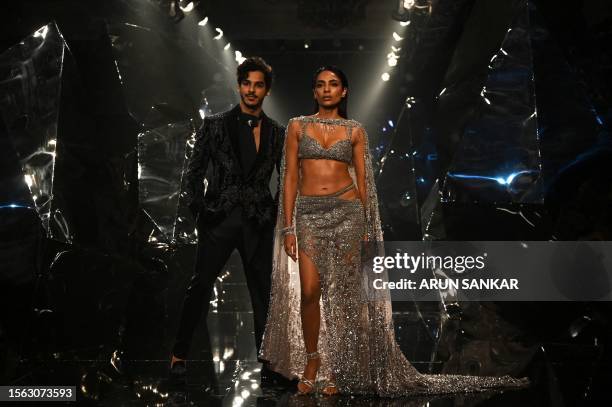 Bollywood actor Ishaan Khatter and actress Sobhita Dhulipala present creations by designers Rohit Gandhi and Rahul Khanna during the FDCI India...