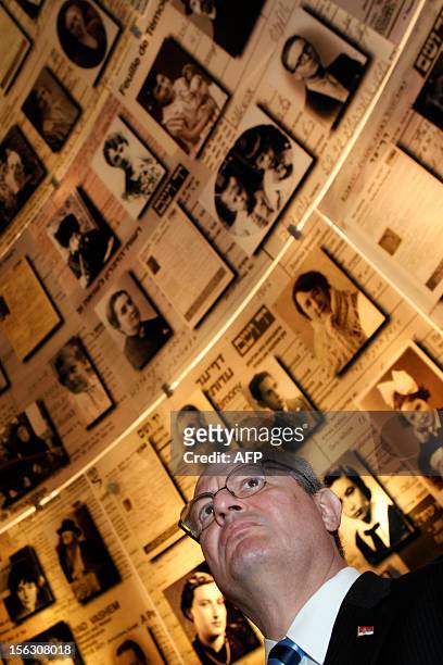 Serbian Foreign Minister Ivan Mrkic looks at pictures of Jewish Holocaust victims at the Hall of Names on November 13 during his visit to the Yad...