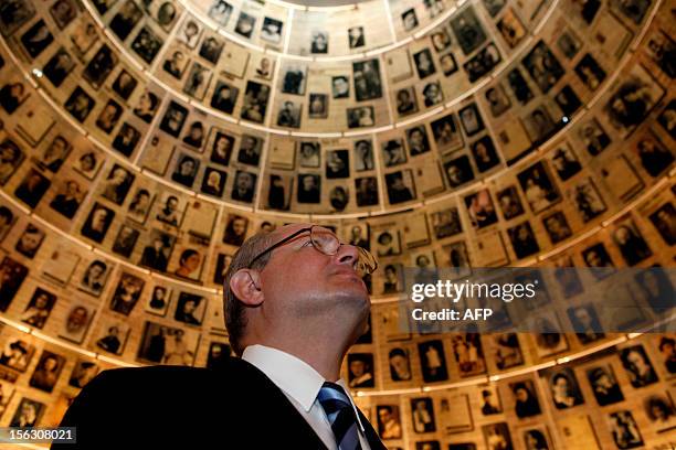 Serbian Foreign Minister Ivan Mrkic looks at pictures of Jewish Holocaust victims at the Hall of Names on November 13, 2012 during his visit to the...