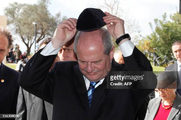 Serbian Foreign Minister Ivan Mrkic wears a kippa, the traditional Jewish skullcap for men on November 13 during his visit to the Yad Vashem...