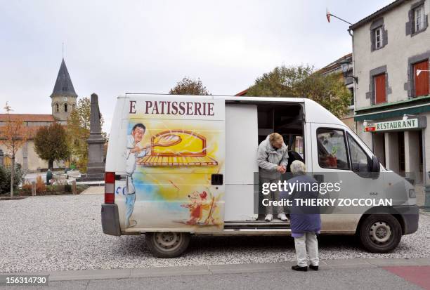 Woman sells bread in a truck used as a mobile bakery on November 13, 2012 in Varenne-sur-Morge, central France. AFP PHOTO THIERRY ZOCCOLAN