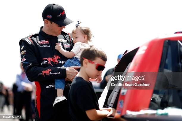 Kyle Busch, driver of the Zariz Transport Chevrolet, spends time with his daughter, Lennix Busch and son, Brexton Busch on the grid prior to the...