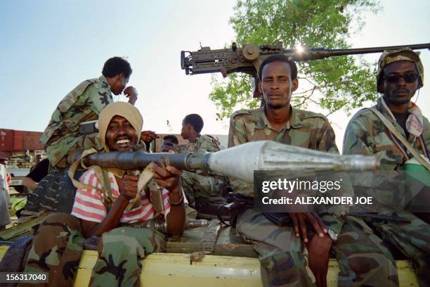 Clan fighter of General Mohamed Aidid holds a rocket launcher aboard a heavy-submachine gun manned pick up as they patrol at the Mogadishu port on...