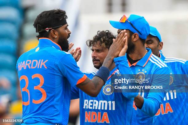 Hardik Pandya and Kuldeep Yadav of India celebrate the dismissal of Shimron Hetmyer of West Indies during the 2nd ODI cricket match between West...
