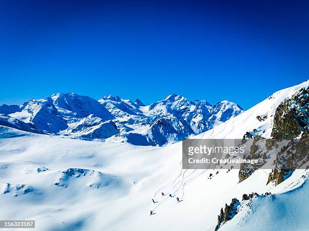 several people skiing down the snowy mountain - switzerland ski stock pictures, royalty-free photos & images