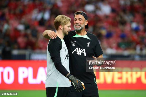 Jurgen Klopp, manager of Liverpool shares a moment with Caoimhin Kelleher during training ahead of the pre-season friendly match between Liverpool...