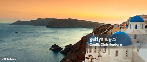 oia panoramic sunset, santorini, greece - steeple stock pictures, royalty-free photos & images