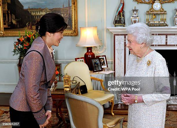 Queen Elizabeth II talks with the Prime Minister of Thailand Mrs Yingluck Shinawatra during a private audience at Buckingham Palace on November 13,...