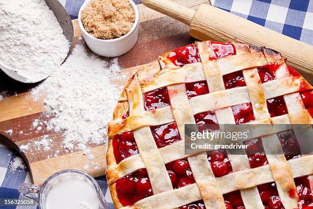 homemade cherry pie on blue gingham checked tablecloth - cherry pie stockfoto's en -beelden