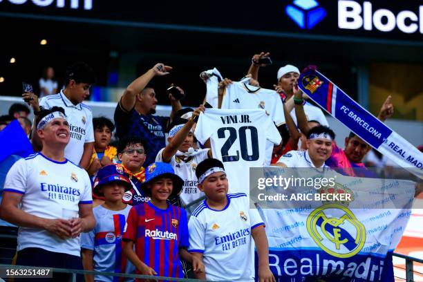 Fan cheers before the start of a pre-season friendly football match between FC Barcelona and Real Madrid CF at AT&T Stadium in Arlington, Texas on...