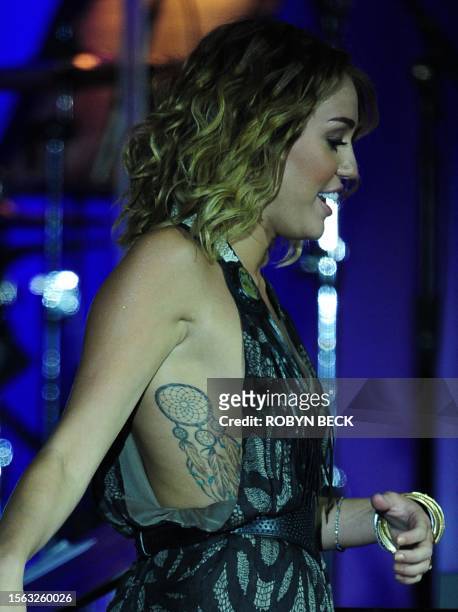 Miley Cyrus performs on stage at Muhammad Ali's Celebrity Fight Night XVIII on March 24, 2012 in Phoenix, Arizona. The event supports the fight...
