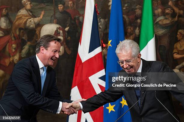 British Prime Minister David Cameron shakes hands with Italian Prime Minister Mario Monti during a press conference at Palazzo Chigi on November 13,...