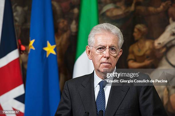 Italian Prime Minister Mario Monti gestures as he attends a press conference with British Prime Minister David Cameron at Palazzo Chigi on November...