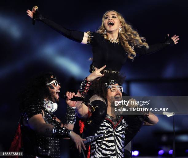 Singer Madonna performs with Redfoo and Sky Blu of LMFAO during the NFL Super Bowl XLVI game halftime show on February 5, 2012 at Lucas Oil Stadium...