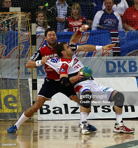 Tobias Karlsson of Flensburg is challenged by Jurecki Bartosz of Magdeburg during the DKB Handball Bundesliga match between SG Flensburg-Handewitt...