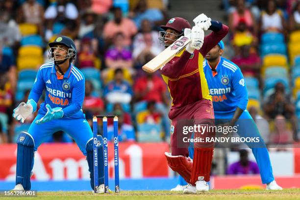 Keacy Carty of West Indies hits 4 as Ishan Kishan of India watches during the 2nd ODI cricket match between West Indies and India, at Kensington Oval...