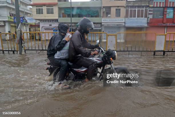 Vehicles move through the waterlogged Sikar Road following heavy monsoon rains, in Jaipur, Rajasthan, India, Saturday, July 29, 2023.