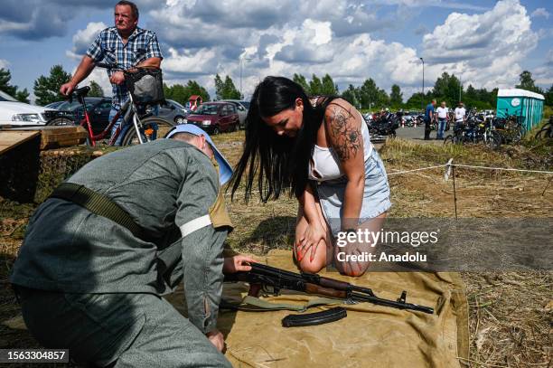 Woman learns how to assemble a AK-47 during a Military picnic on July 29, 2023 in Zawiercie, Poland. Poland's military picnics take place during the...