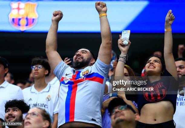 Fan cheers before the start of a pre-season friendly football match between FC Barcelona and Real Madrid CF at AT&T Stadium in Arlington, Texas on...