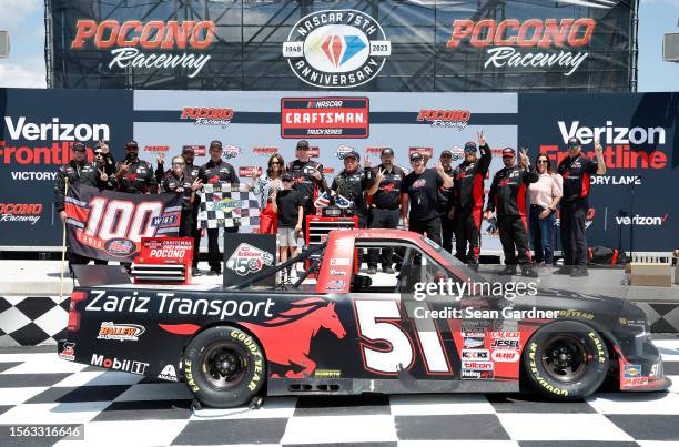 Kyle Busch, driver of the Zariz Transport Chevrolet, celebrates with crew and family in victory lane after winning NASCAR Craftsman Truck Series CRC...