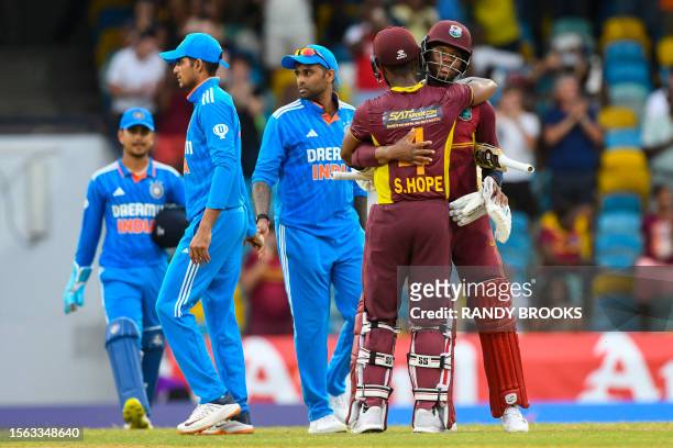 Shai Hope and Keacy Carty of West Indies celebrate as Shubman Gill and Suryakumar Yadav of India walk off the field at the end of the 2nd ODI cricket...