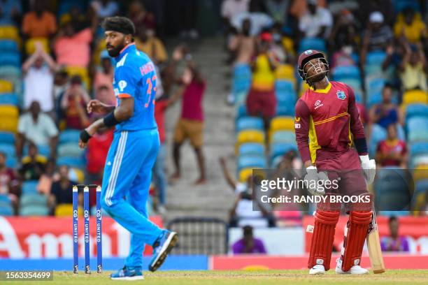 Keacy Carty of West Indies celebrates as Hardik Pandya of India looks back to see the last ball hit the boundary during the 2nd ODI cricket match...