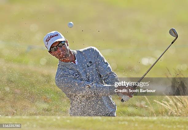 Adam Scott of Australia chips out of a bunker during the Pro-Am Day ahead of the 2012 Australian Masters at Kingston Heath Golf Club on November 14,...