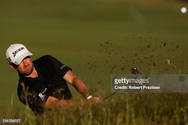 Graeme McDowell of Northern Ireland plays a shot out of the bunker ahead of the 2012 Australian Masters at Kingston Heath Golf Club on November 14,...