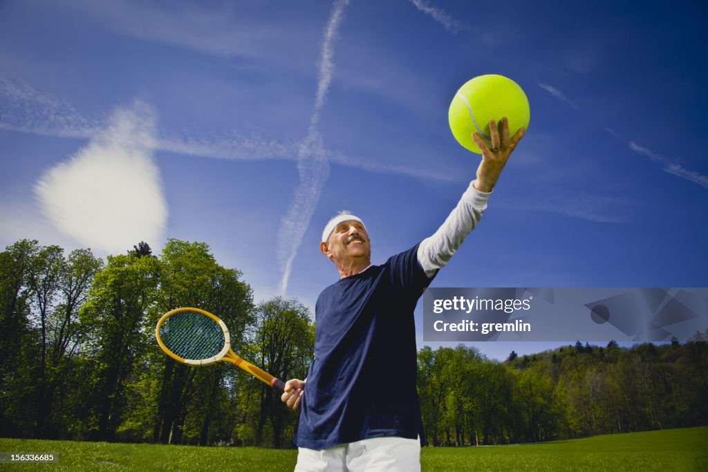 Funny senior adult playing tennis