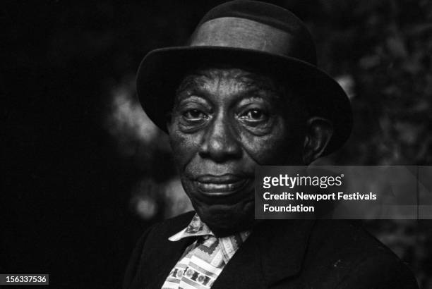 Country folk blues guitarist and singer Mississippi John Hurt poses for a portrait at the Newport Folk Festival in July, 1964 in Newport, Rhode...