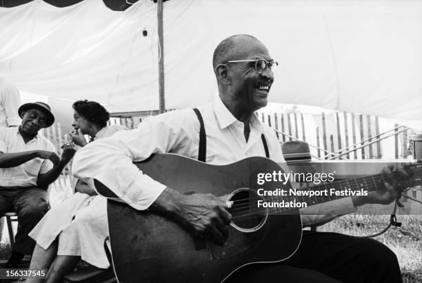 Country blues guitarist, singer and songwriter Reverend Robert Wilkins performs in July, 1964 at an afternoon blues workshop at the Newport Folk...