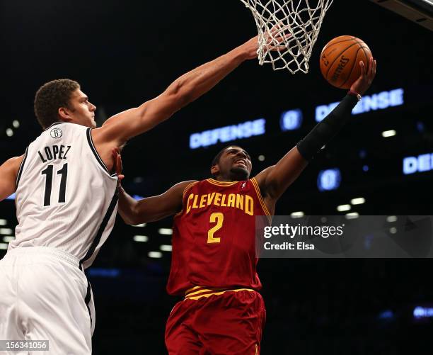 Kyrie Irving of the Cleveland Cavaliers heads for the net as Brook Lopez of the Brooklyn Nets defends on November 13, 2012 at the Barclays Center in...