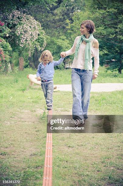 slackline - woman tightrope stock pictures, royalty-free photos & images