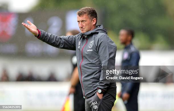 Billy McKinlay, the West Ham United first team coach issues instructions during the pre-season friendly match between Dagenham & Redbridge and West...