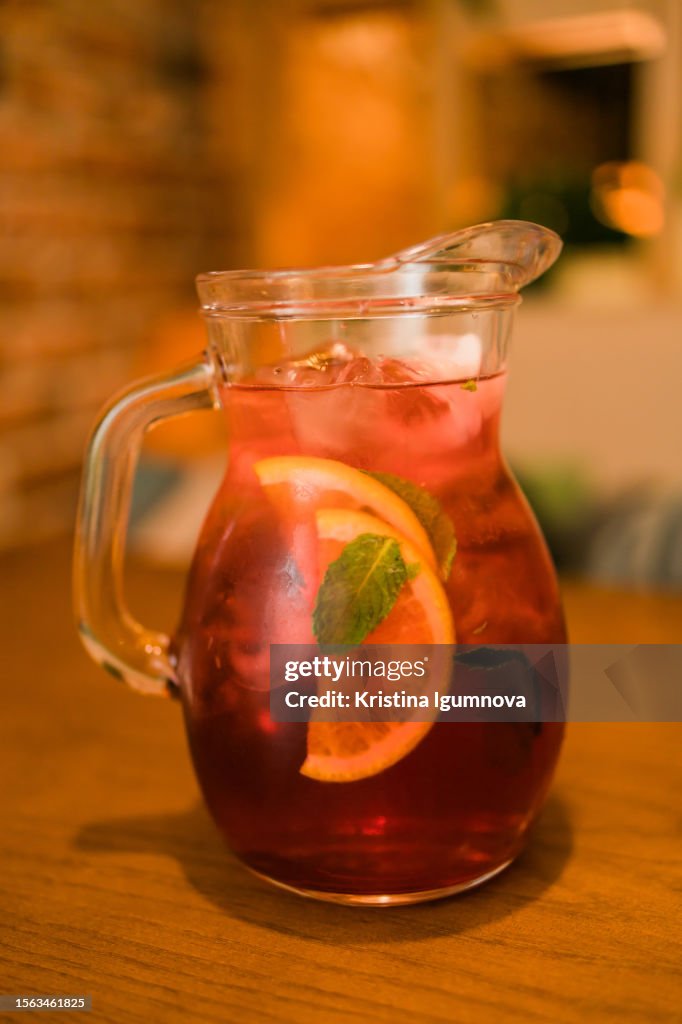 Jug of raspberry lemonade with ice. Summer cold drink
