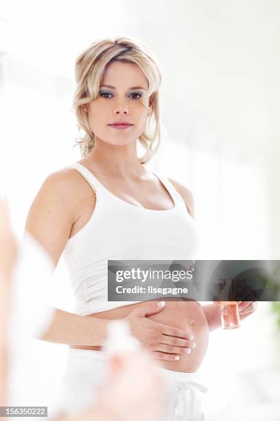 pregnant woman in mirror - stretch mark stock pictures, royalty-free photos & images