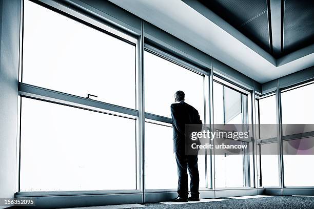 solitary businessman - corner office stock pictures, royalty-free photos & images