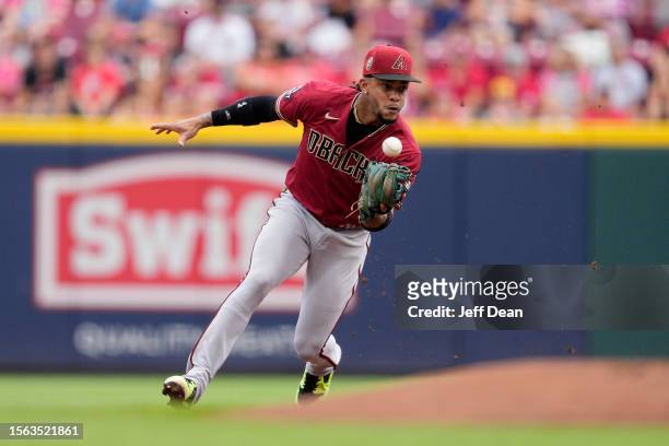 Ketel Marte of the Arizona Diamondbacks makes a fielding error on a fielders choice hit by TJ Friedl of the Cincinnati Reds in the first inning of a...