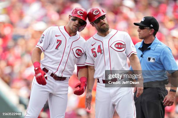 Spencer Steer of the Cincinnati Reds celebrates with Collin Cowgill after hitting a single against the Arizona Diamondbacks in the first inning of a...