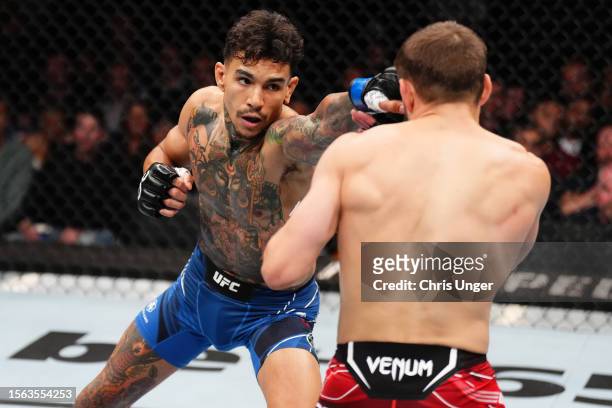 Andre Fili punches Nathaniel Wood of England in their featherweight fight during the UFC Fight Night at The O2 Arena on July 22, 2023 in London,...