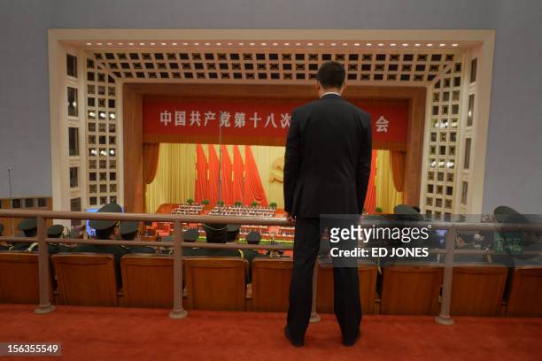 Security guard stands inside the Great Hall of the People during the closing ceremony of the Communist Party Congress in Beijing on November 14,...