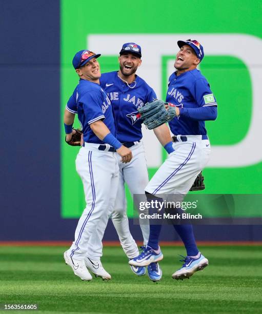 Daulton Varsho, Kevin Kiermaier, and George Springer of the Toronto Blue Jays celebrate defeating the Los Angeles Angels in their MLB game at the...