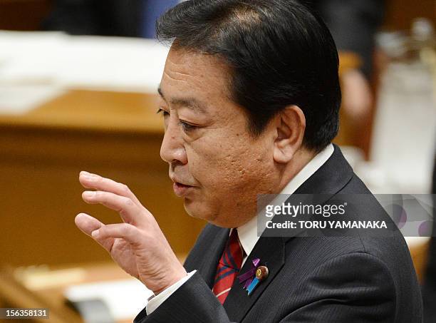 Japanese Prime Minister Yoshihiko Noda gestures during a one-by-one debate with President of the main opposition Liberal Democratic Party Shinzo Abe...