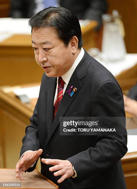 Japanese Prime Minister Yoshihiko Noda gestures during a one-by-one debate with President of the main opposition Liberal Democratic Party Shinzo Abe...