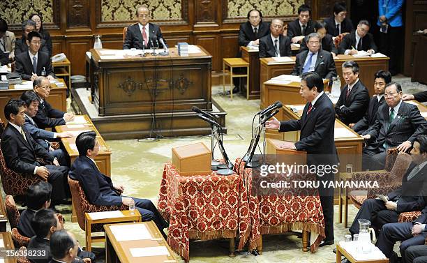 Japanese Prime Minister Yoshihiko Noda answers questions from President of the main oppositon Liberal Democratic Party Shinzo Abe duing a one-by-one...