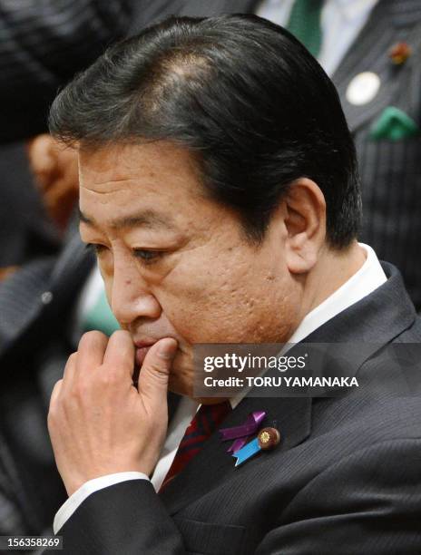 Japanese Prime Minister Yoshihiko Noda reacts as he listens to questions during a one-by-one debate with President of the main opposition Liberal...