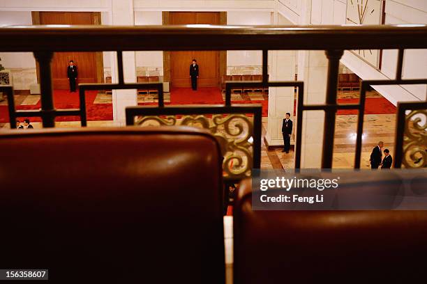 Soldiers dressed as ushers guard at the entrance of the meeting room during the closing session of the 18th National Congress of the Communist Party...