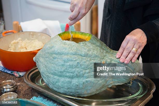 Resident Lisa Jorgenson puts together a s stuffed vegetarian Hubbard squash. Risotto is put into the squash first.