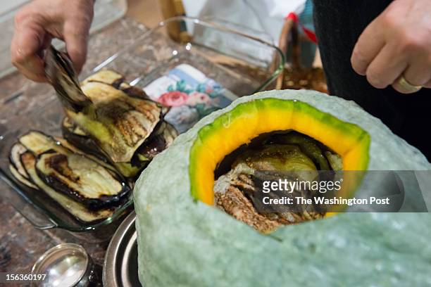 Resident Lisa Jorgenson puts together a s stuffed vegetarian Hubbard squash. Eggplant is the second layer.